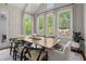 Spacious dining room with lots of windows, modern decor and stylish light fixture at 705 Abbington River Ln, Atlanta, GA 30339