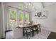 Bright dining room features vaulted ceiling, modern light fixture and expansive windows with beautiful views at 705 Abbington River Ln, Atlanta, GA 30339
