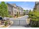 Charming townhomes boast well-manicured landscaping and inviting curb appeal within a gated community at 705 Abbington River Ln, Atlanta, GA 30339