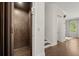Hallway with elevator, neutral paint, hardwood floors, staircase and white trim at 705 Abbington River Ln, Atlanta, GA 30339