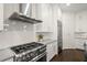 Modern kitchen featuring stainless steel appliances, white cabinets, and a tile backsplash at 705 Abbington River Ln, Atlanta, GA 30339