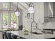 Bright kitchen featuring a large island with seating, stainless steel appliances, and modern light fixtures at 705 Abbington River Ln, Atlanta, GA 30339
