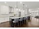 Open kitchen with stainless steel appliances, white cabinets, large center island with bar stool seating at 705 Abbington River Ln, Atlanta, GA 30339