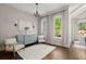Living room with large windows, hardwood floors, stylish decor, and ample natural light at 705 Abbington River Ln, Atlanta, GA 30339
