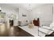 Cozy living room with hardwood floors, sofa, chairs, and view to the dining area at 705 Abbington River Ln, Atlanta, GA 30339