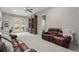 Spacious living room with comfortable leather seating and a well-lit workspace at 705 Abbington River Ln, Atlanta, GA 30339