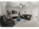 Comfortable living room featuring a large screen TV and modern shelving at 705 Abbington River Ln, Atlanta, GA 30339