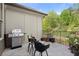 Cozy outdoor patio with grill, seating area, and lush green views at 705 Abbington River Ln, Atlanta, GA 30339
