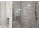 Enclosed shower features elegant tile, rainfall shower head, and neutral tones to create a spa-like feel at 705 Abbington River Ln, Atlanta, GA 30339
