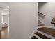 Staircase and entryway of the home featuring a modern gray color palette and hardwood steps at 705 Abbington River Ln, Atlanta, GA 30339