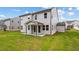 Spacious backyard showcasing the home's exterior with a covered patio and lush green lawn at 719 Crossroad Ct, Powder Springs, GA 30127
