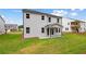 View of backyard and rear exterior of house featuring a covered porch and windows at 719 Crossroad Ct, Powder Springs, GA 30127