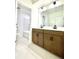 Bathroom showcasing double vanity, light wood cabinets, and shower/tub combo at 719 Crossroad Ct, Powder Springs, GA 30127