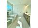 Bright bathroom showcasing a glass shower, soaking tub, double vanity, and marble floors at 719 Crossroad Ct, Powder Springs, GA 30127