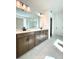 Bathroom featuring double vanity, light wood cabinets, and large mirror at 719 Crossroad Ct, Powder Springs, GA 30127
