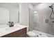 Modern bathroom featuring walk-in shower with glass door, sleek vanity, and neutral color palette at 719 Crossroad Ct, Powder Springs, GA 30127