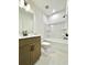 Bathroom featuring single vanity with brown cabinets and a bathtub/shower combo at 719 Crossroad Ct, Powder Springs, GA 30127