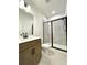 Bathroom featuring single vanity with brown cabinets and a glass-enclosed shower at 719 Crossroad Ct, Powder Springs, GA 30127