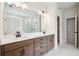 Modern bathroom featuring a double sink vanity, large mirror, and walk-in shower with glass door at 719 Crossroad Ct, Powder Springs, GA 30127