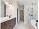 Bright bathroom with double vanity, glass shower, and soaking tub at 719 Crossroad Ct, Powder Springs, GA 30127