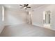 Spacious primary bedroom with plush carpet, ceiling fan, and an ensuite bathroom at 719 Crossroad Ct, Powder Springs, GA 30127