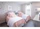 Bright bedroom decorated with twin beds, colorful wallpaper, and decorative pillows at 719 Crossroad Ct, Powder Springs, GA 30127