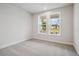 Bright bedroom with carpet and two windows overlooking the front yard at 719 Crossroad Ct, Powder Springs, GA 30127