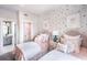 Charming bedroom decorated with twin beds, colorful wallpaper, and decorative pillows at 719 Crossroad Ct, Powder Springs, GA 30127