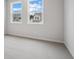 Bright bedroom with two windows, plush carpet, and neutral walls at 719 Crossroad Ct, Powder Springs, GA 30127
