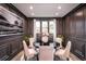 Elegant dining room with dark walls, modern lighting, and a circular table at 719 Crossroad Ct, Powder Springs, GA 30127