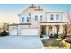 Beautiful two-story home with three-car garage, light brick, and professionally landscaped front yard at 719 Crossroad Ct, Powder Springs, GA 30127