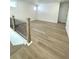 Bright hallway with modern wood-style flooring and a sleek black metal railing at 719 Crossroad Ct, Powder Springs, GA 30127