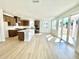Open-concept kitchen with large island, brown cabinets, and stainless steel appliances, flowing into a bright living area at 719 Crossroad Ct, Powder Springs, GA 30127