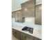 Kitchen with gray cabinets, white backsplash, quartz countertops and a gas stovetop at 719 Crossroad Ct, Powder Springs, GA 30127