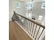Bright, two-story living room with a modern fireplace, large windows, and an open floor plan, viewed from staircase at 719 Crossroad Ct, Powder Springs, GA 30127