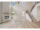 Spacious living room with a modern fireplace, large windows, and an open staircase at 719 Crossroad Ct, Powder Springs, GA 30127