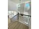 Bright, two-story living room with a modern fireplace, large windows, and an open floor plan, viewed from staircase at 719 Crossroad Ct, Powder Springs, GA 30127