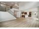 Spacious living room with light wood floors, an open floor plan, and staircase at 719 Crossroad Ct, Powder Springs, GA 30127