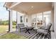 Covered patio with comfortable seating and sliding glass doors, providing seamless indoor-outdoor living at 719 Crossroad Ct, Powder Springs, GA 30127