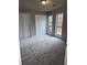 Spacious bedroom with ample closet space, large windows, and new carpeting at 980 Fox Chase Ln, Riverdale, GA 30296