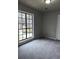 Bedroom featuring a large window, neutral colors, and new carpeting at 980 Fox Chase Ln, Riverdale, GA 30296