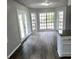 Bright dining room with large windows, backyard view, and modern finishes at 980 Fox Chase Ln, Riverdale, GA 30296