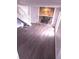 Cozy living room with a stone fireplace, modern hardwood flooring, and a staircase at 980 Fox Chase Ln, Riverdale, GA 30296