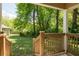 View of the lush backyard with a wooden fence and mature trees from the porch at 1104 Victory Sw Dr, Atlanta, GA 30310