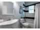 Clean bathroom featuring a shower/tub, tiled walls, and black and white accents at 1104 Victory Sw Dr, Atlanta, GA 30310
