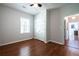 This bedroom features a ceiling fan, window with blinds, closet, and wood-look floors at 1104 Victory Sw Dr, Atlanta, GA 30310