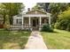 Charming home featuring a covered front porch with decorative columns and lovely flower boxes at 1104 Victory Sw Dr, Atlanta, GA 30310