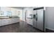 Spacious kitchen with stainless steel refrigerator, granite countertops, and ample cabinet space at 1104 Victory Sw Dr, Atlanta, GA 30310