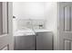 The laundry room features a white washer, dryer, and shelving unit at 1104 Victory Sw Dr, Atlanta, GA 30310