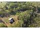 Aerial view of a home surrounded by lush trees and a winding driveway at 896 Winn Rd, Douglasville, GA 30134